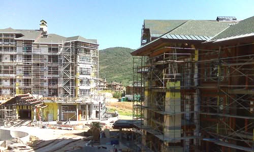 A construction site for a large apartment building with new construction plumbing in progress.
